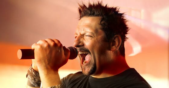 male singer who appears to be yelling into the microphone