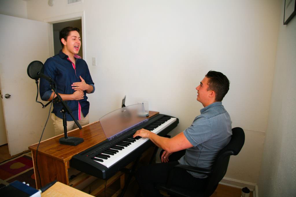 student with voice teacher at piano