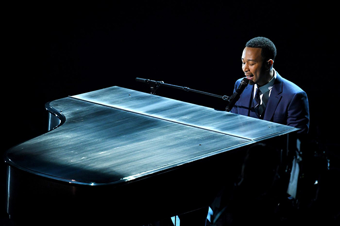 John Legend playing piano and singing