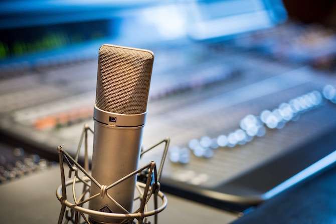 a microphone with a recording studio in the background