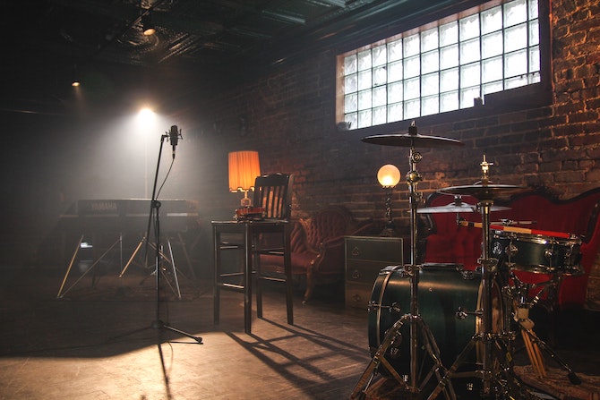 A music rehearsal room with mircrophone, drums and yamaha keyboard