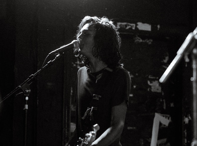 A black and white photo of a singer with long hair